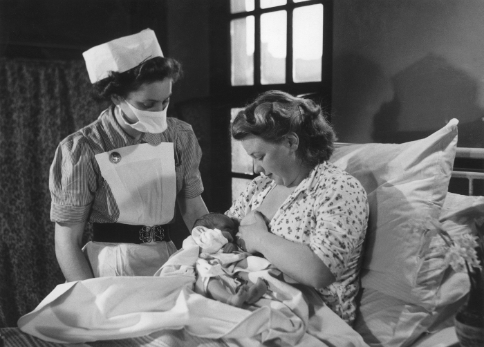 Photograph of a midwife and nursing mother